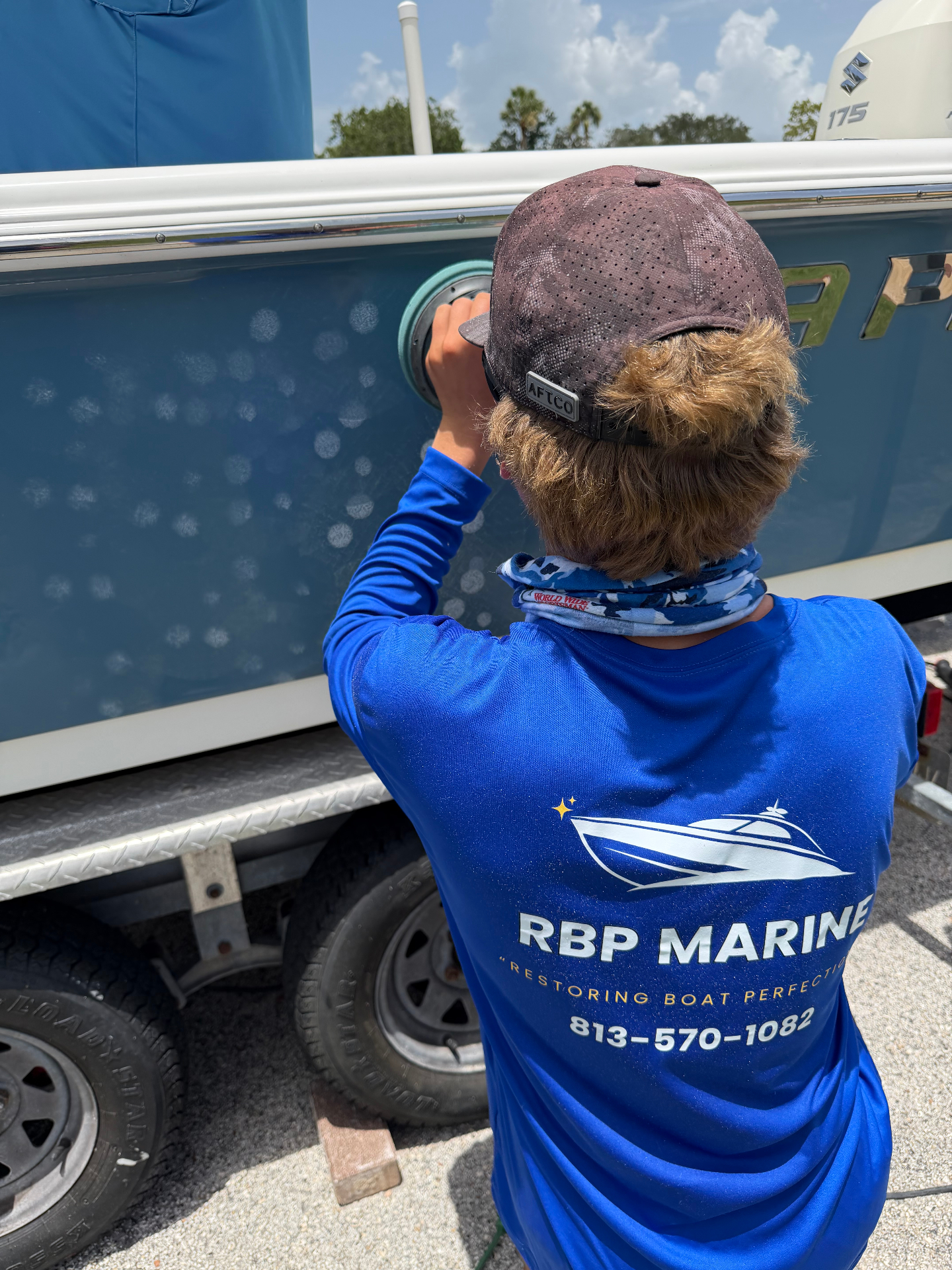 RBP Marine technician machine-polishing a Sea Pro hull side