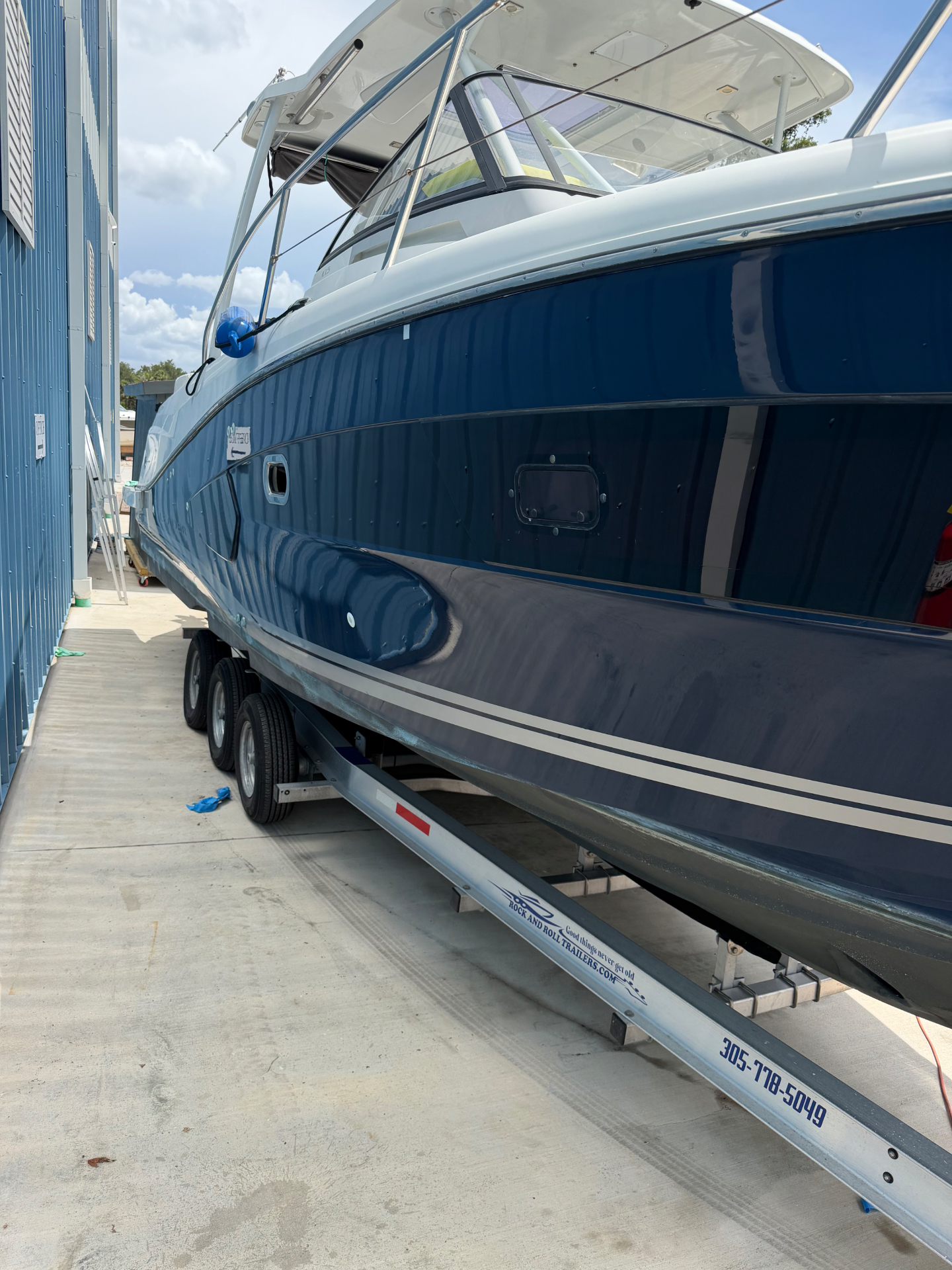 Deep blue hull polished to a mirror finish after gelcoat restoration